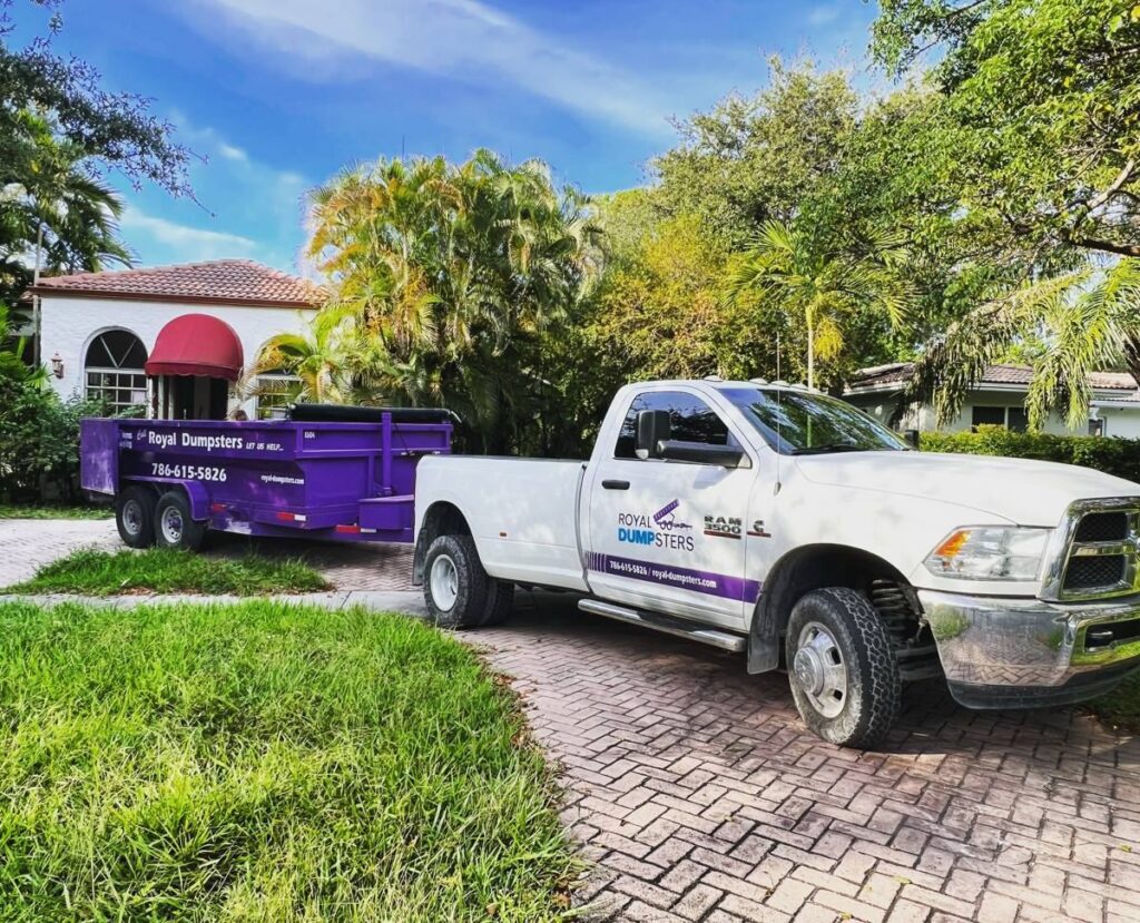 Purple dumpster on a finished driveway in El Portal, FL
