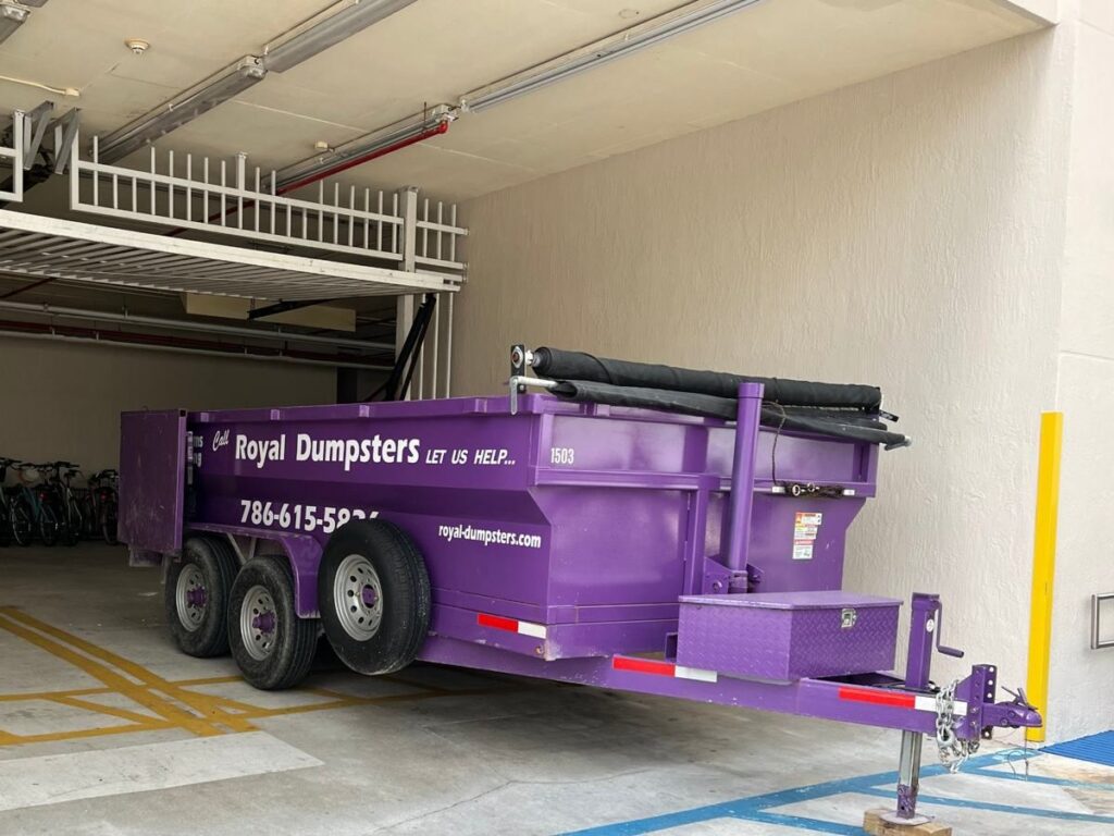 Royal Dumpsters dumpster parked inside a condo parking garage in Fort Lauderdale, FL